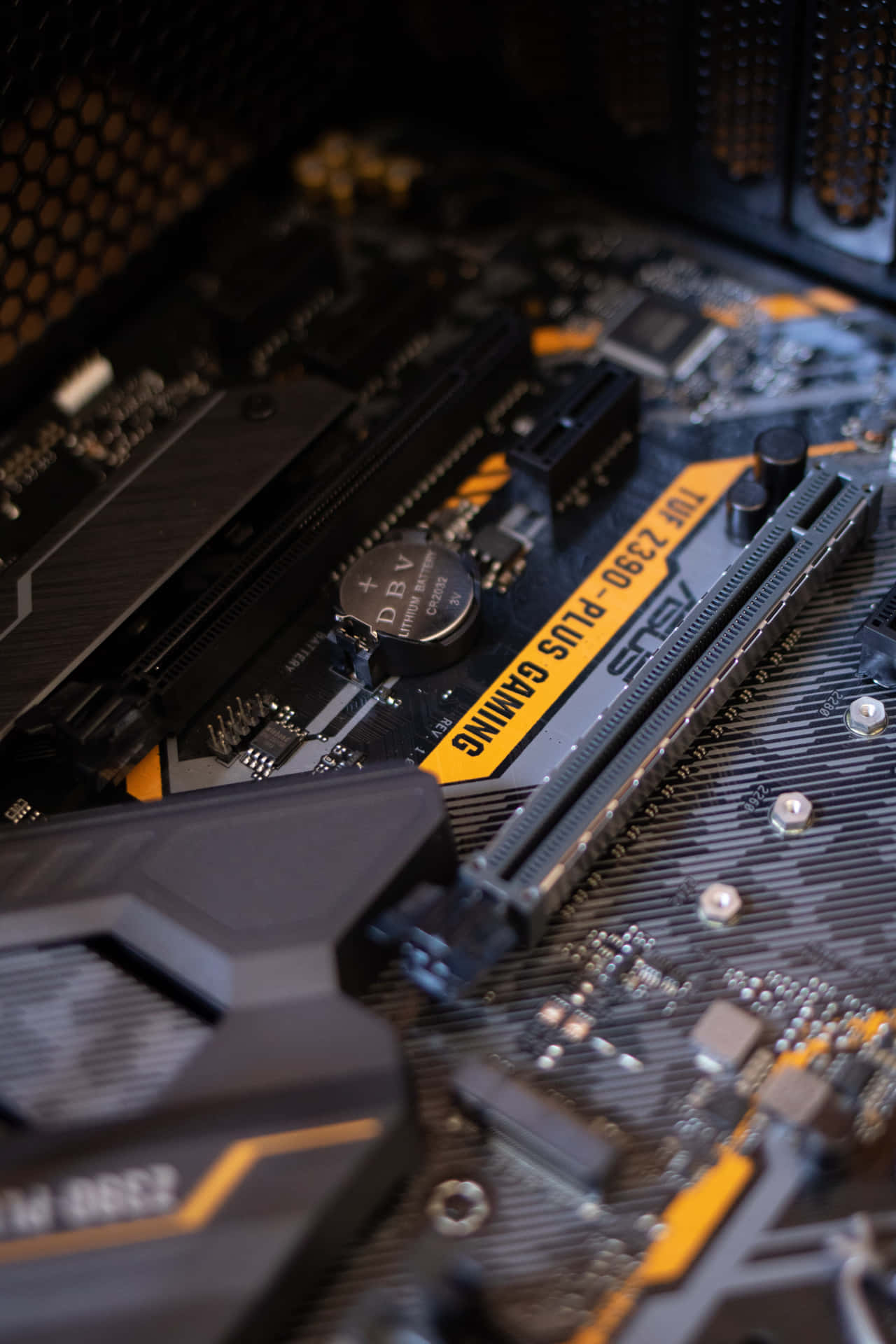 A Close Up Of A Motherboard With A Yellow And Black Motherboard