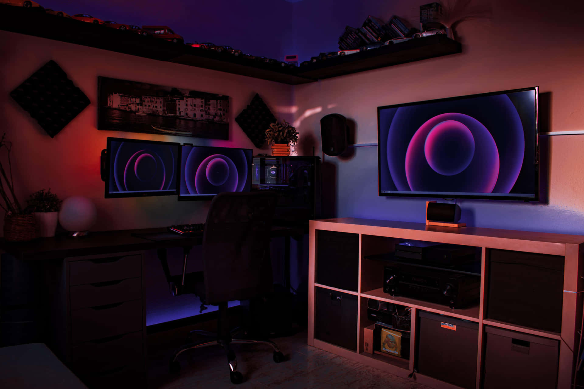 A picture of a well-lit gaming room with a TV and console setup.