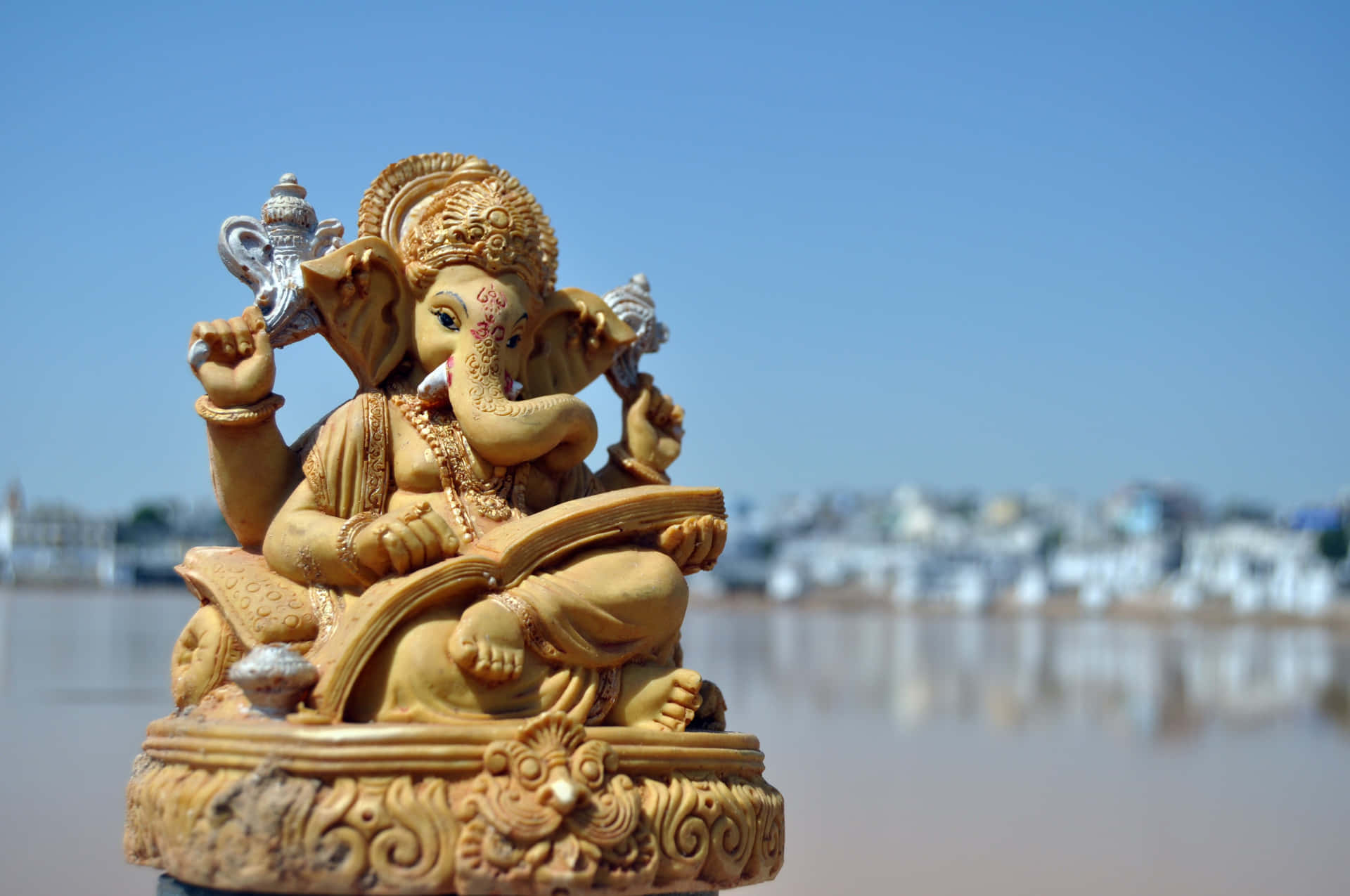 Ganesh Statue In Front Of A Lake
