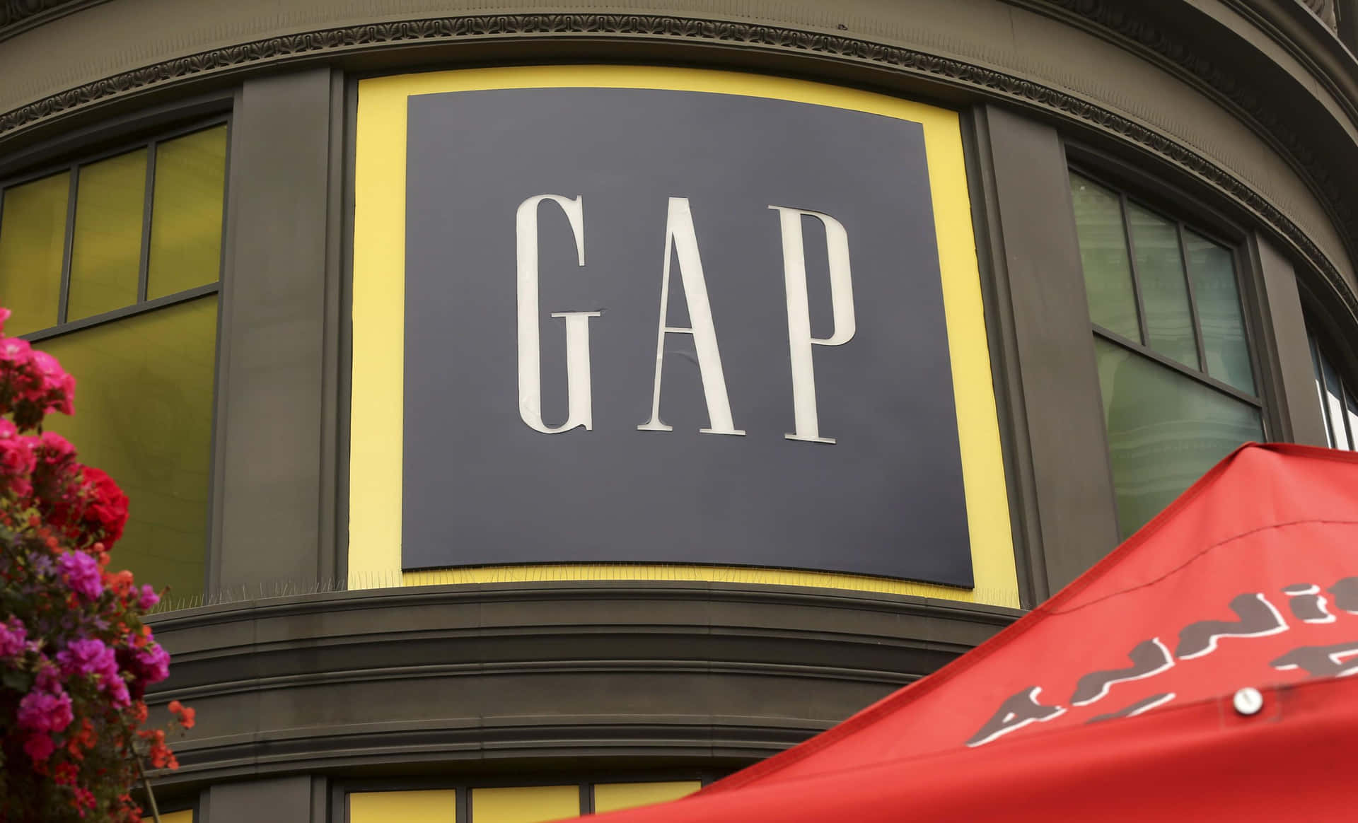 A Gap Store With A Red Umbrella In Front Of It