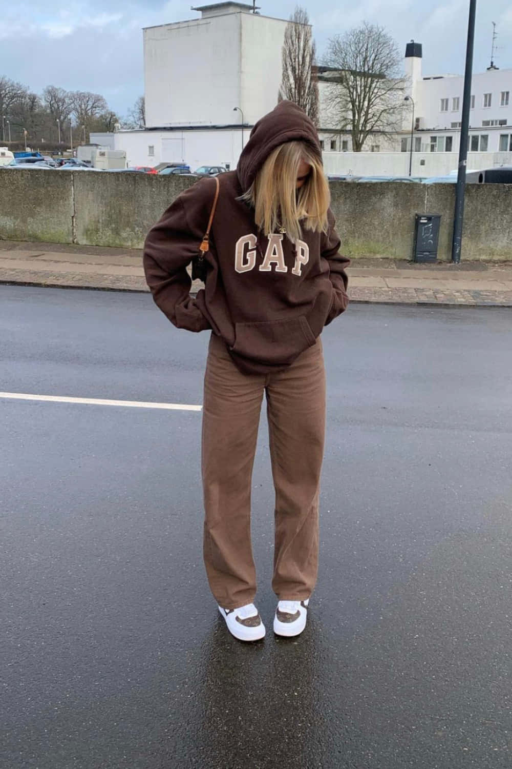 A Woman In Brown Sweat Pants And A Gap Hoodie