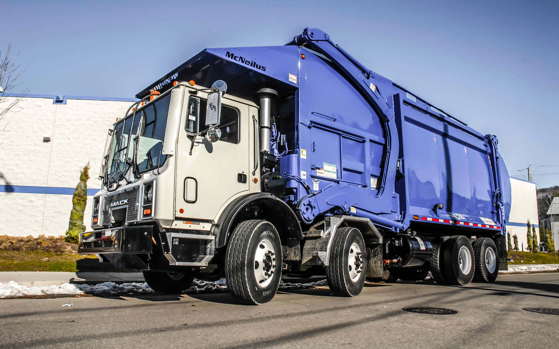 An industrial garbage truck collecting waste in a city