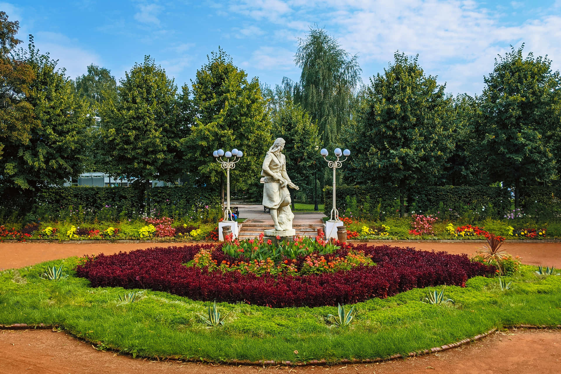 a circular garden with a statue