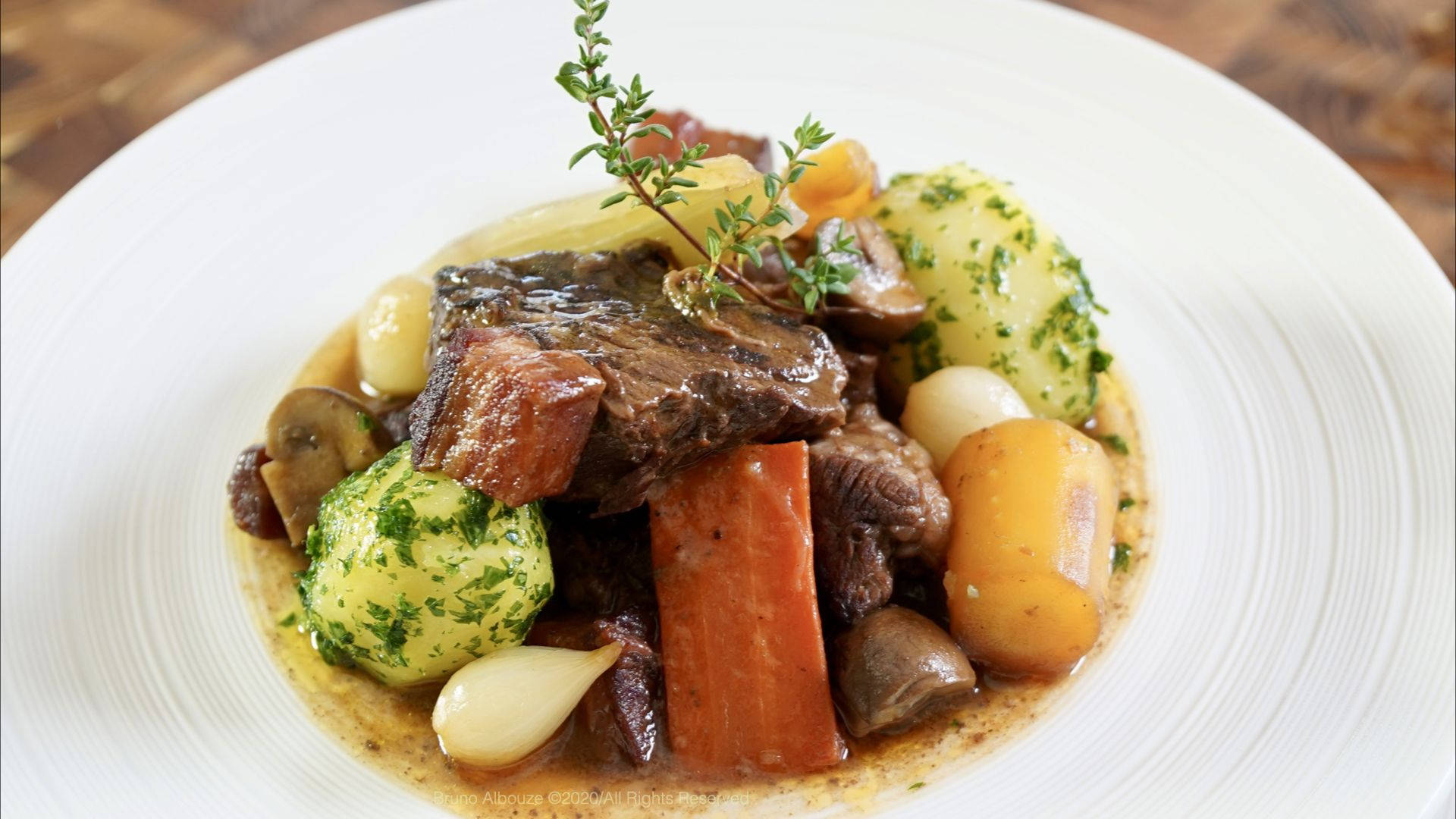 A sumptuous serving of Beef Bourguignon garnished beautifully. Wallpaper
