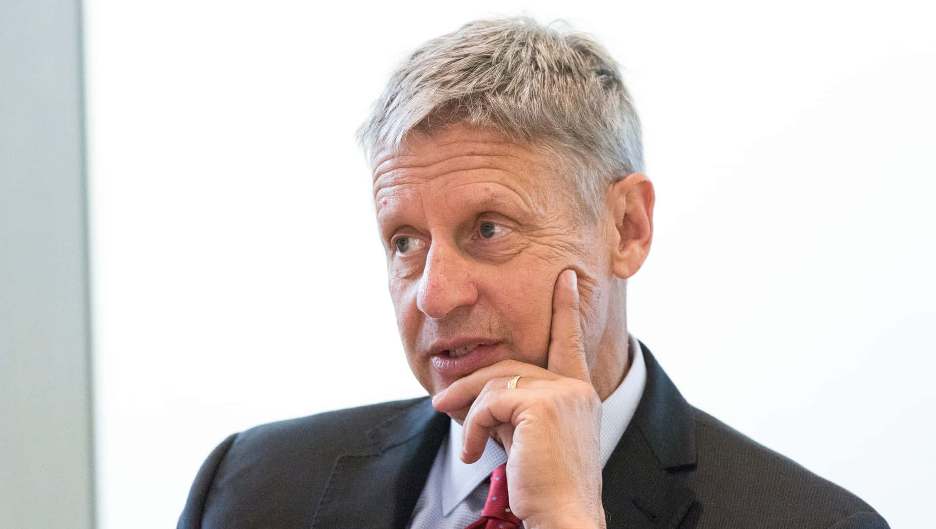 Gary Johnson In A Suit With White Backdrop Wallpaper