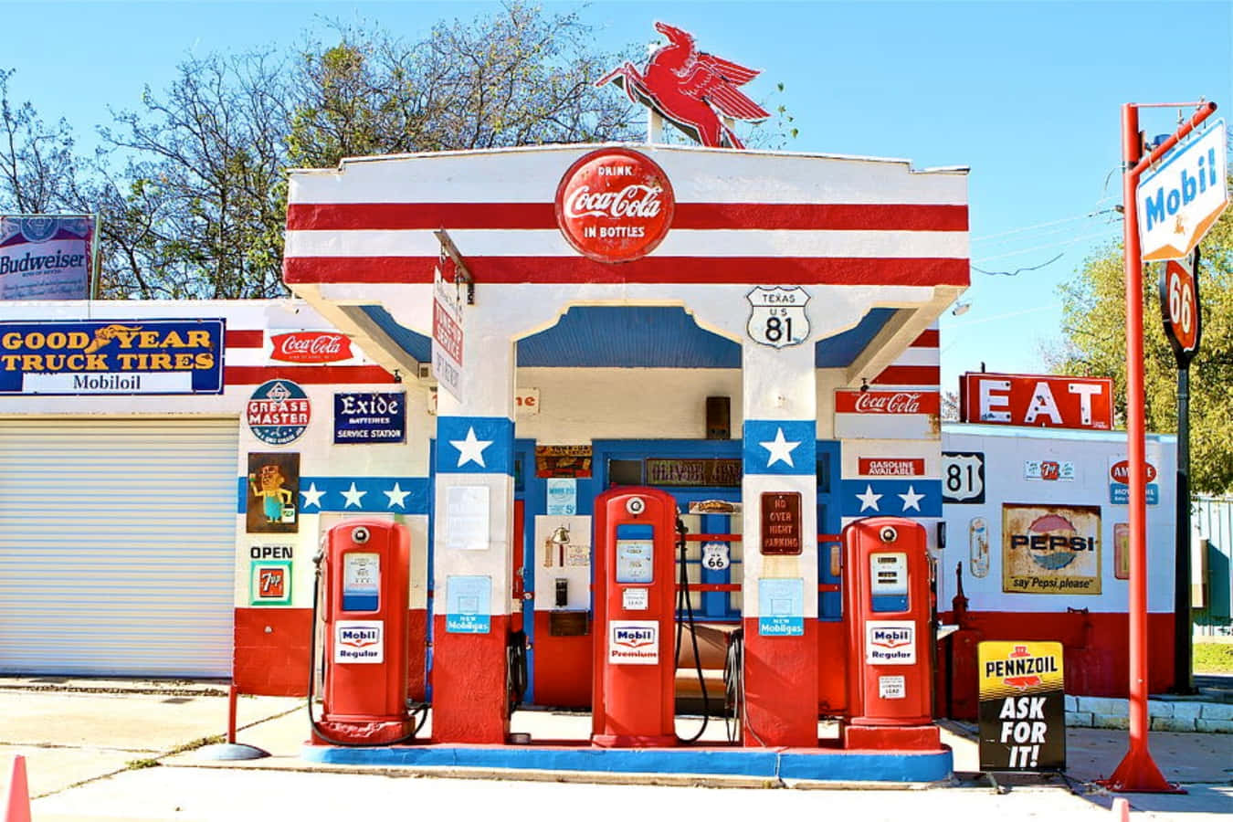A Gas Station With Red, White And Blue Signs