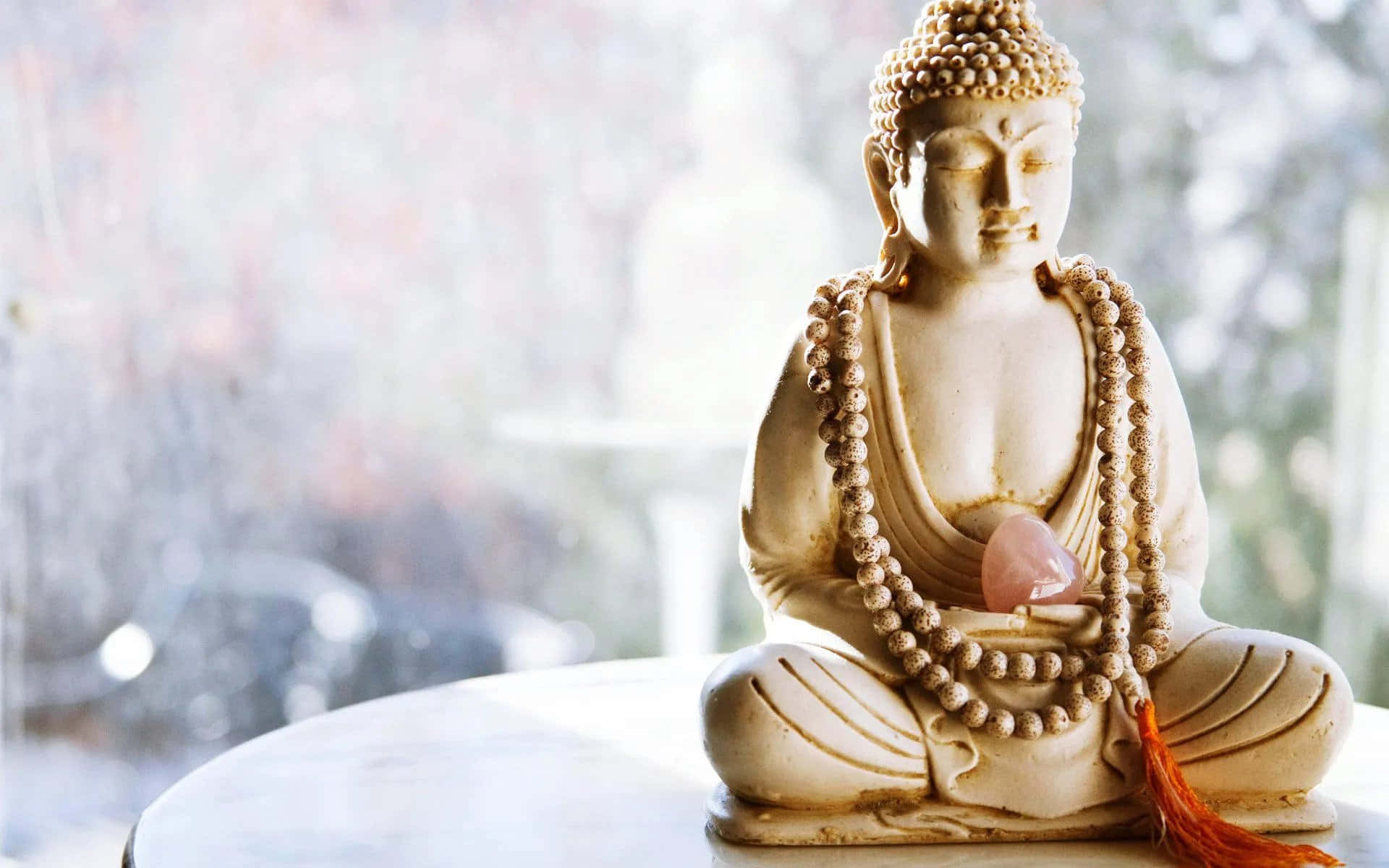 A Buddha Statue Sitting On A Table