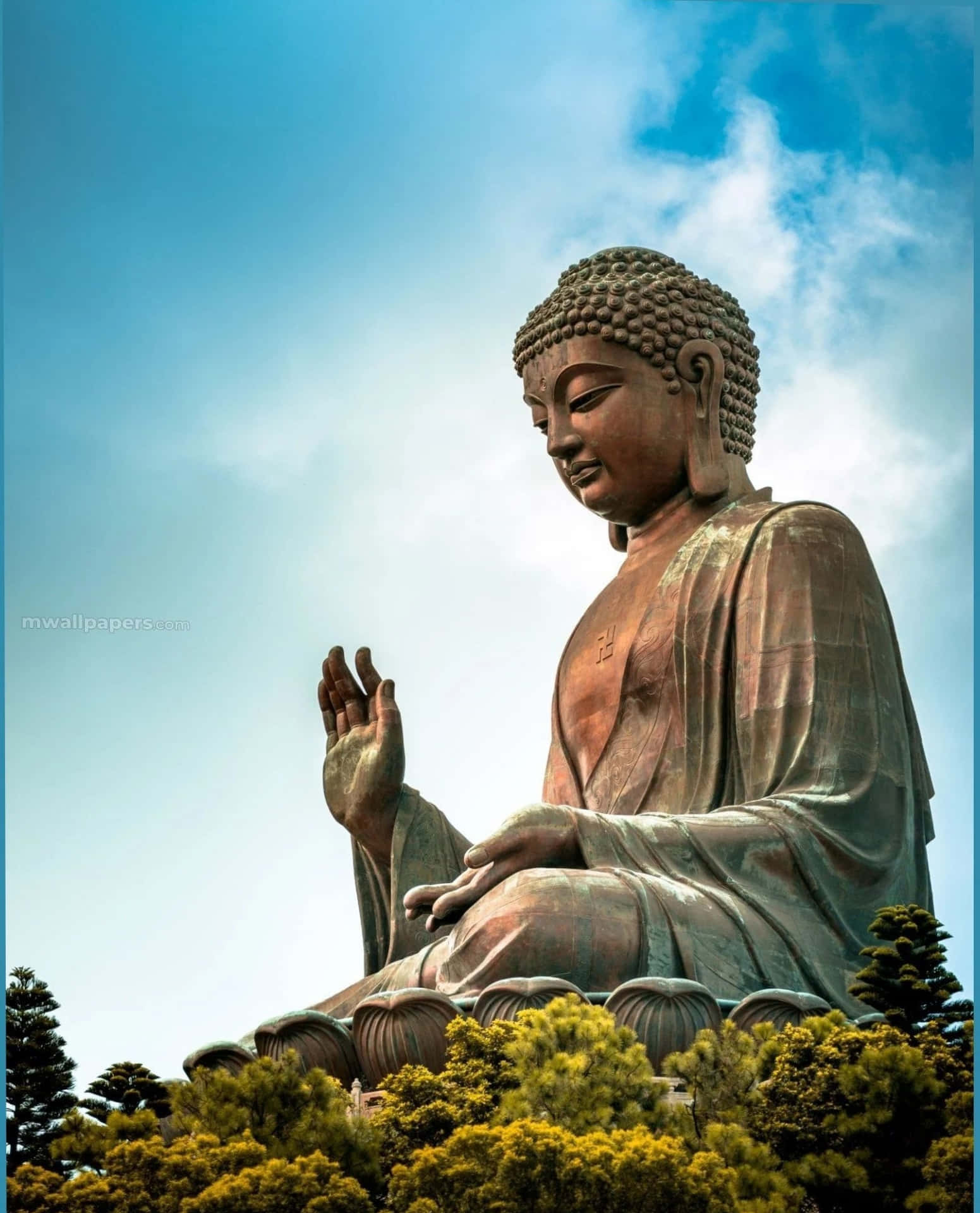 A Large Buddha Statue Is Sitting In The Middle Of A Forest