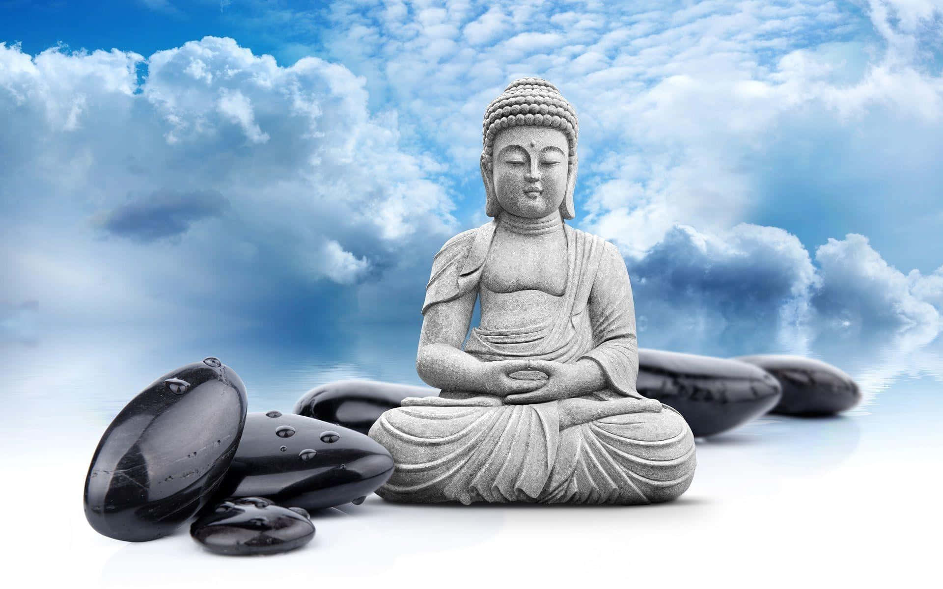 A Buddha Statue With Black Stones And Clouds