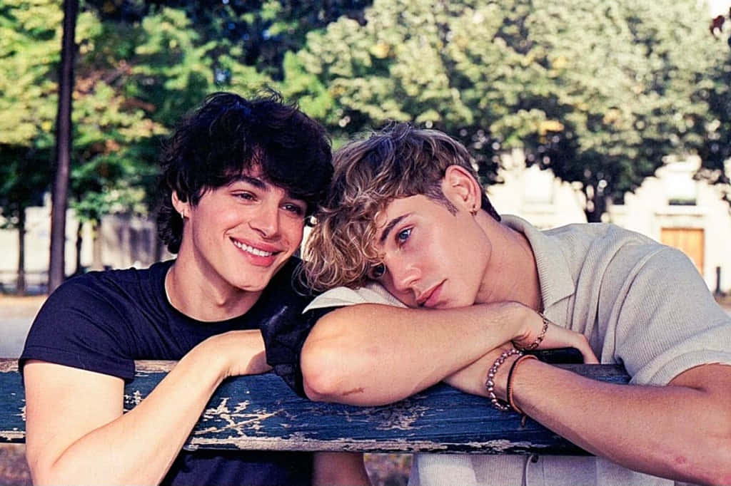 Gay Boys Leaning On The Fence Background