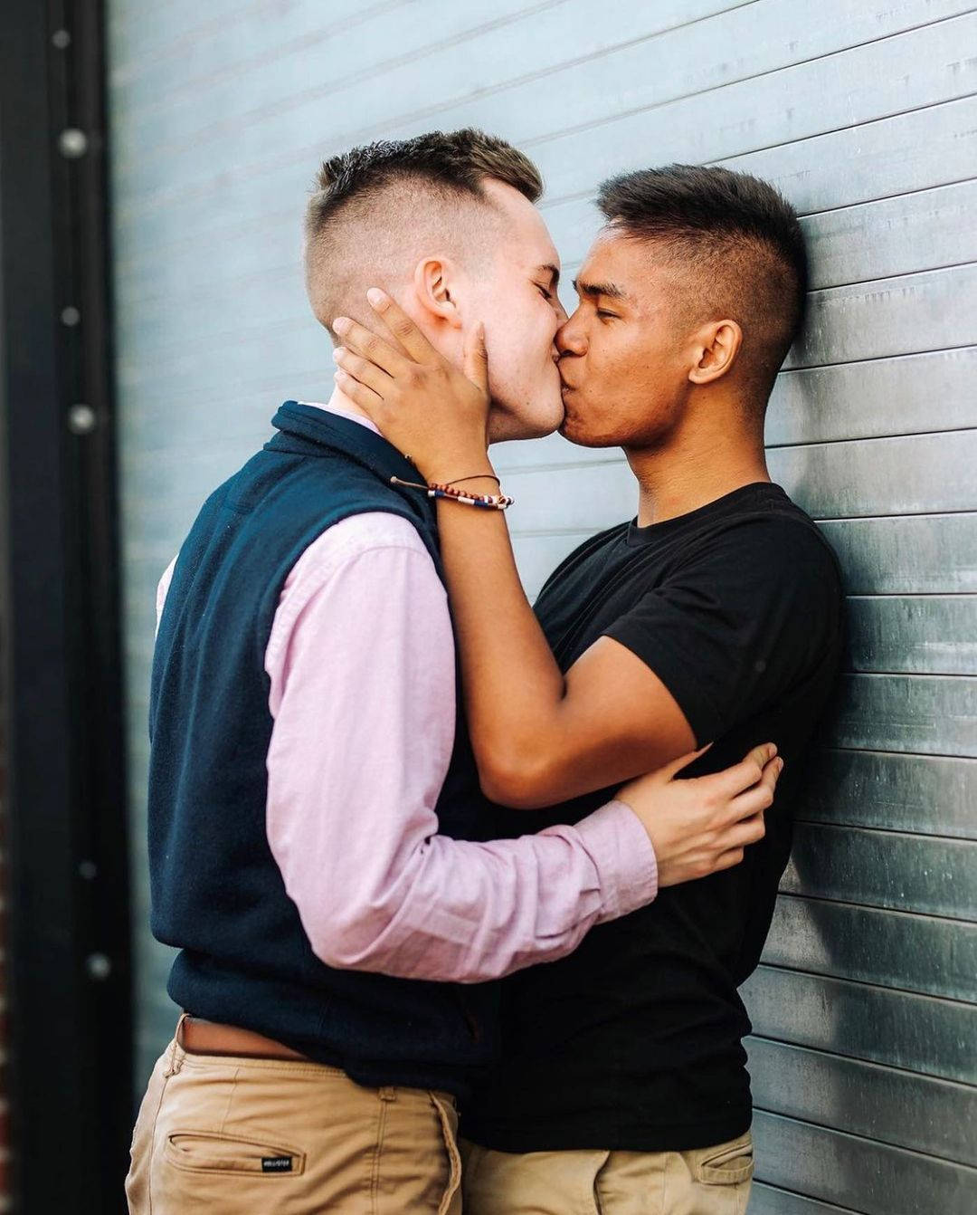 Gay Men Kissing Against Wall Wallpaper