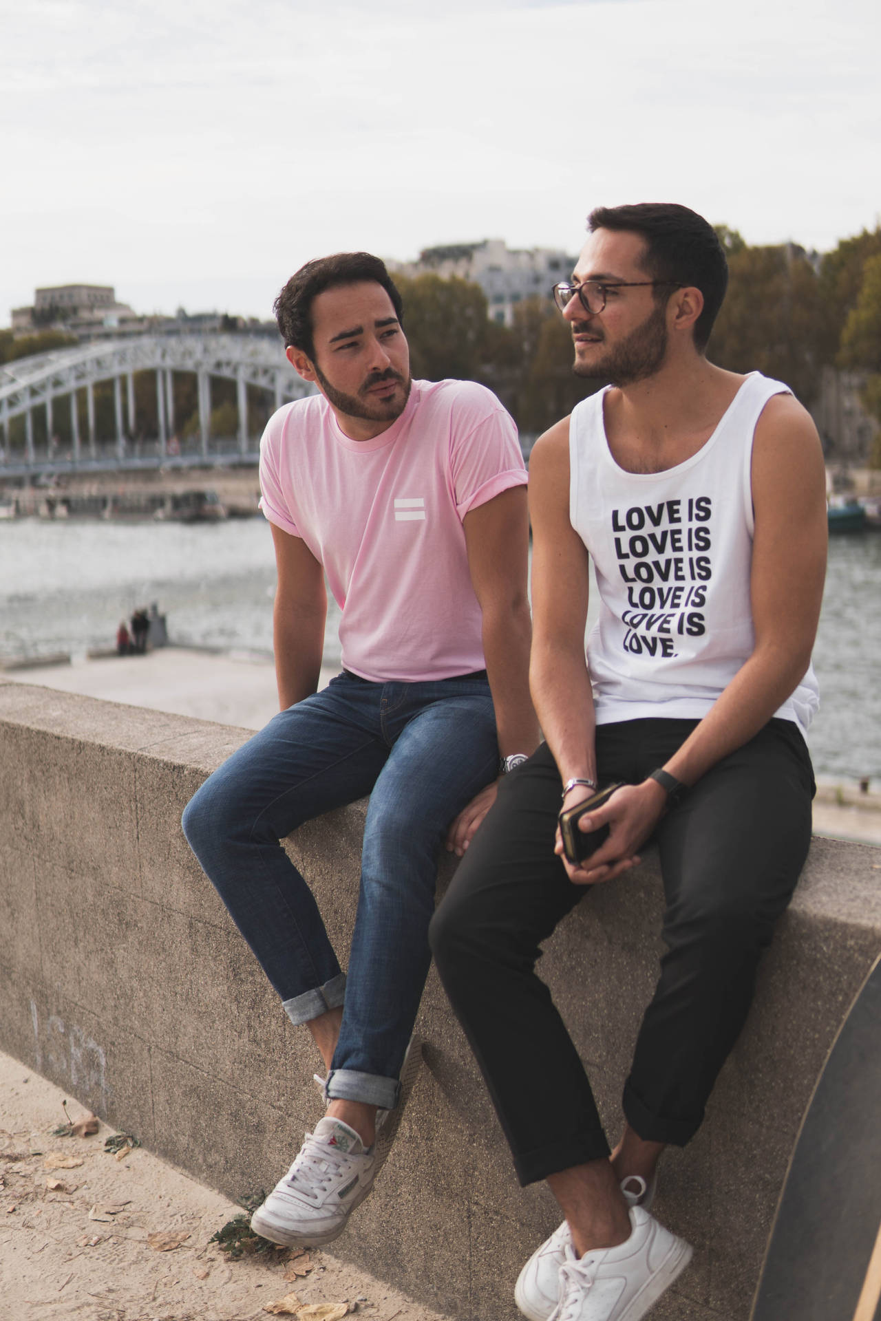Gay Men Sitting On Wall Background