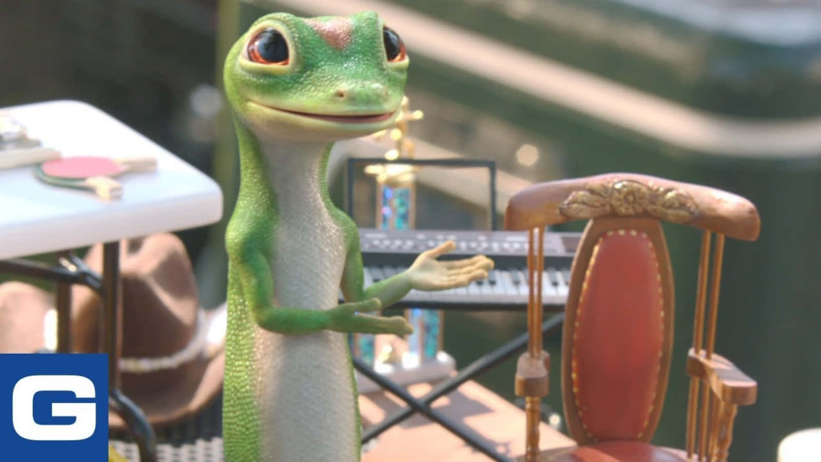 A Green Gecko Is Standing Next To A Piano