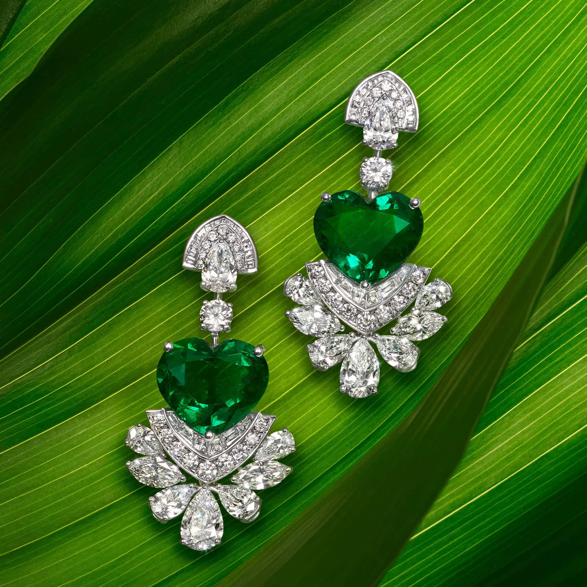 Emerald And Diamond Earrings On Green Leaves