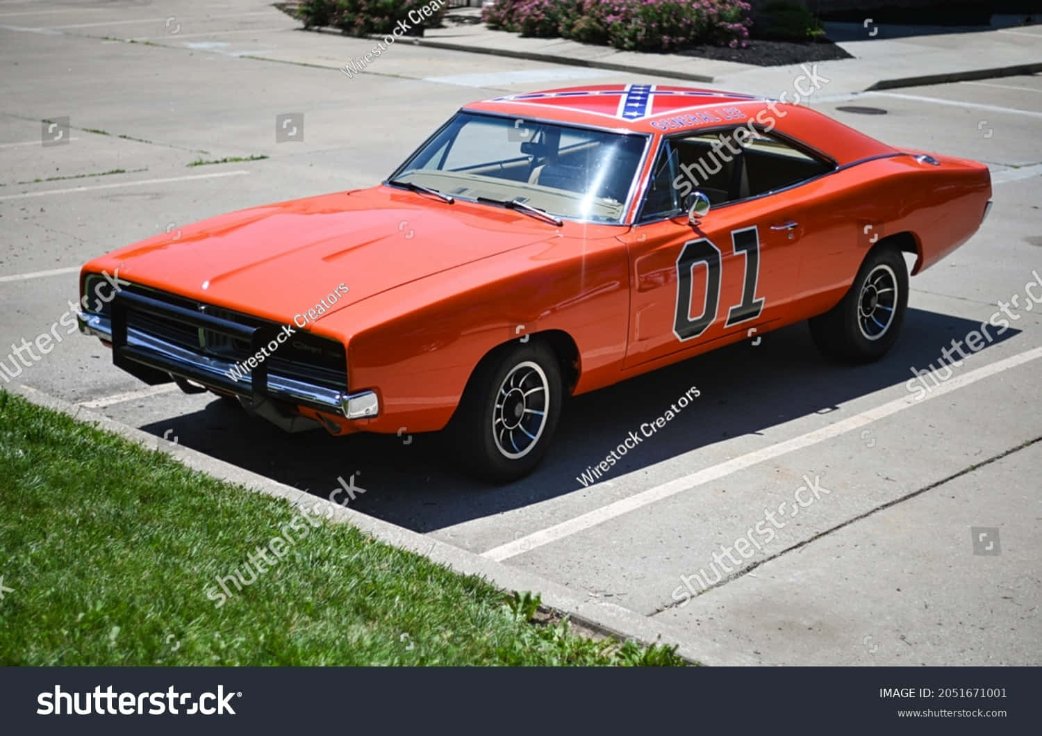 An Orange Dodge Charger Parked In A Parking Lot Wallpaper