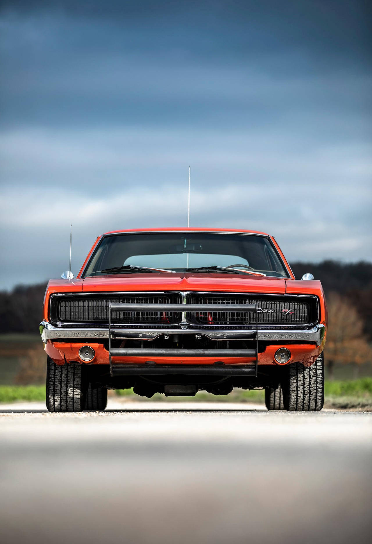 A Red Muscle Car Parked On A Road Wallpaper