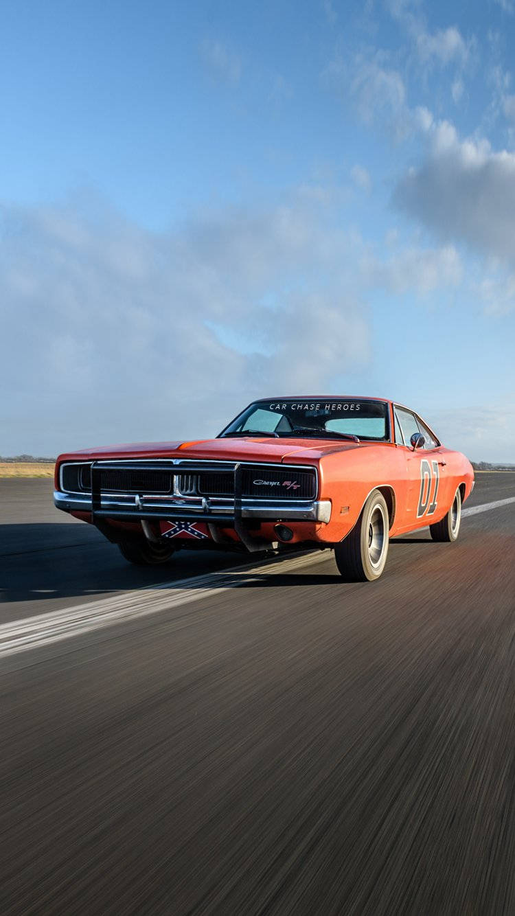 Dodge Charger - A Classic Muscle Car Driving On A Road Wallpaper