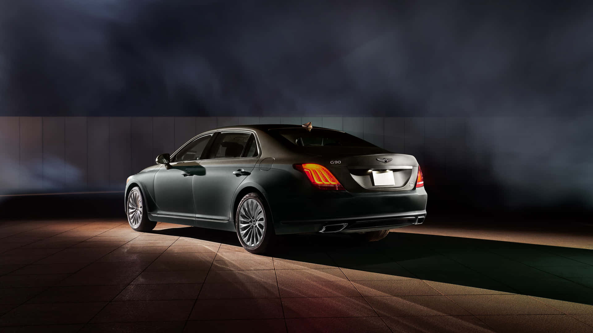 A sleek Genesis G90 in motion on a scenic road Wallpaper