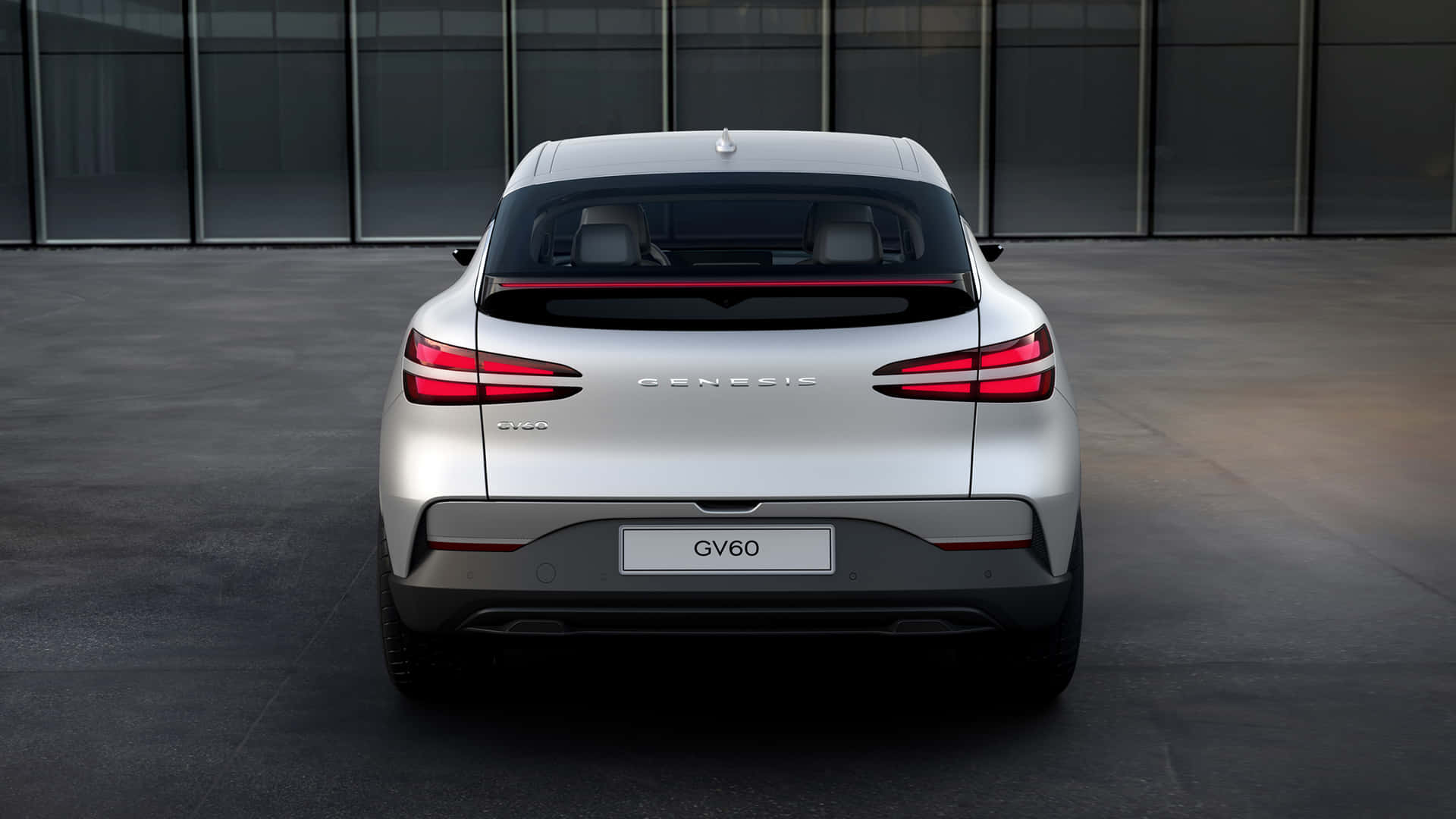 Sleek and stylish Genesis GV60 electric SUV on a scenic road Wallpaper