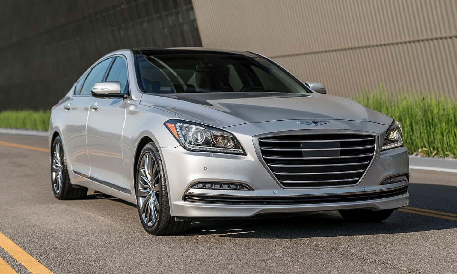 The Silver Hyundai Genesis Is Driving Down The Road