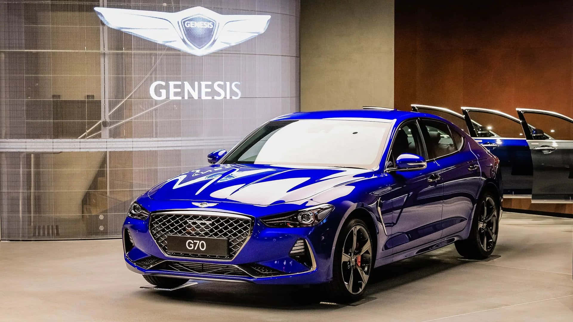 A Blue Genesis Is Parked In A Showroom