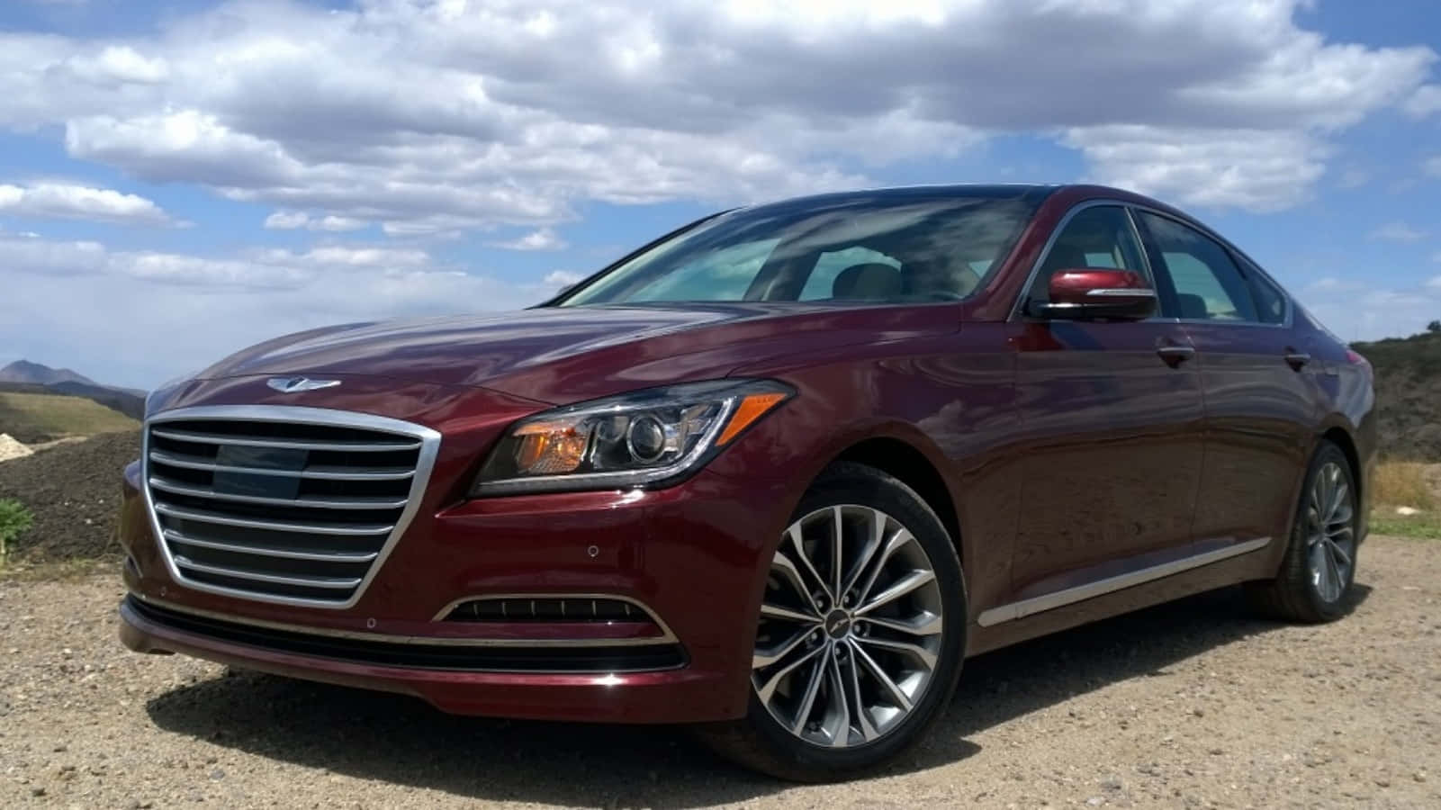 The Red Hyundai Genesis Is Parked On A Dirt Road