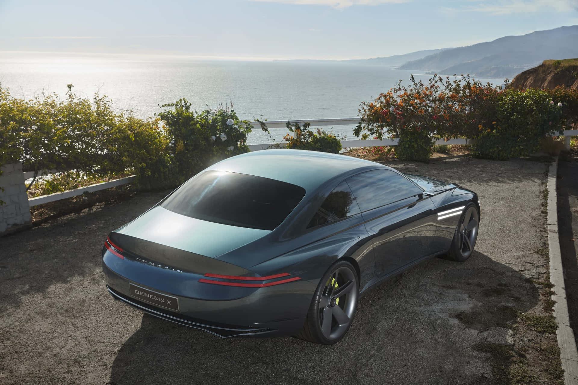 Sleek Genesis X Concept Sports Car on a Scenic Road Wallpaper