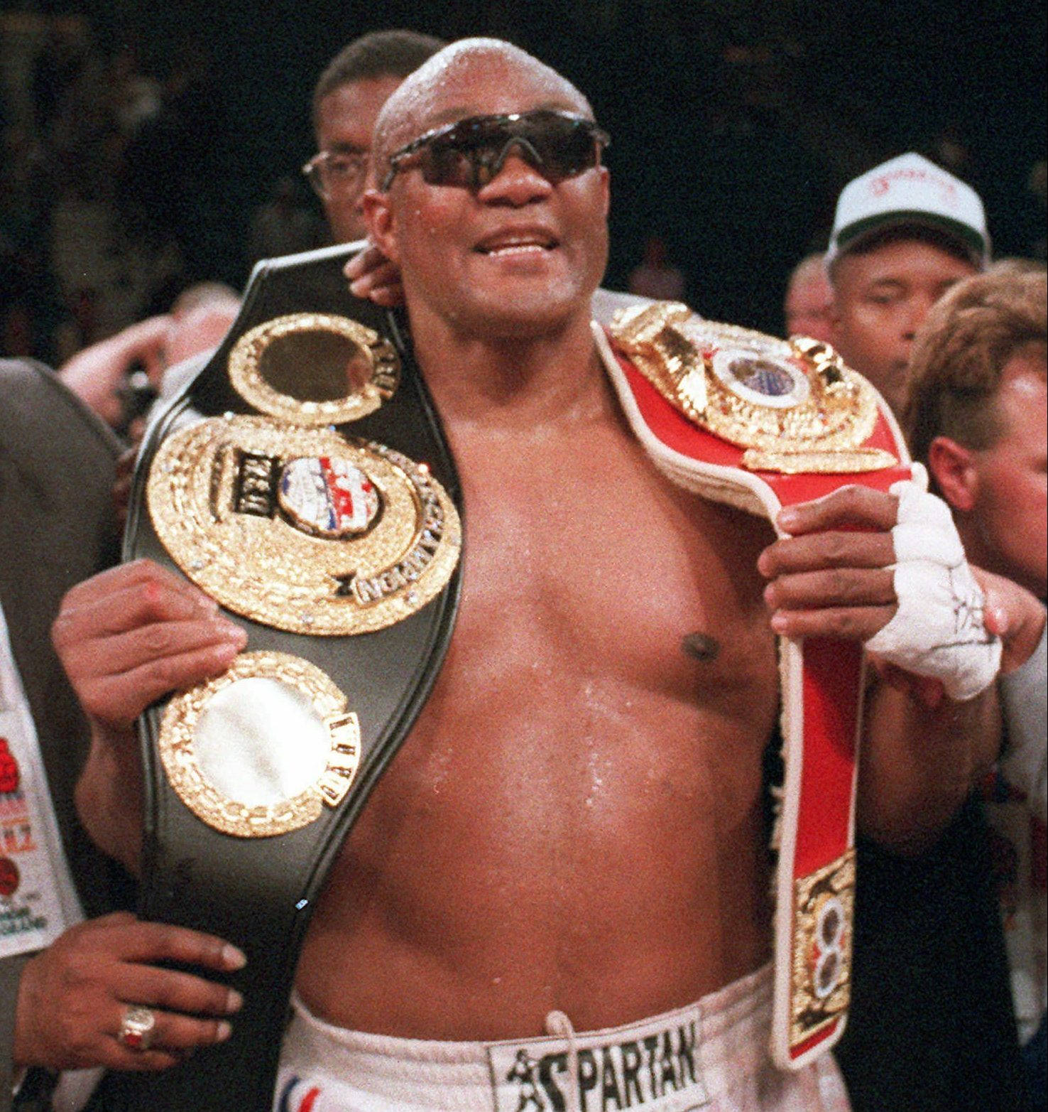 George Foreman With Championship Belts Wallpaper