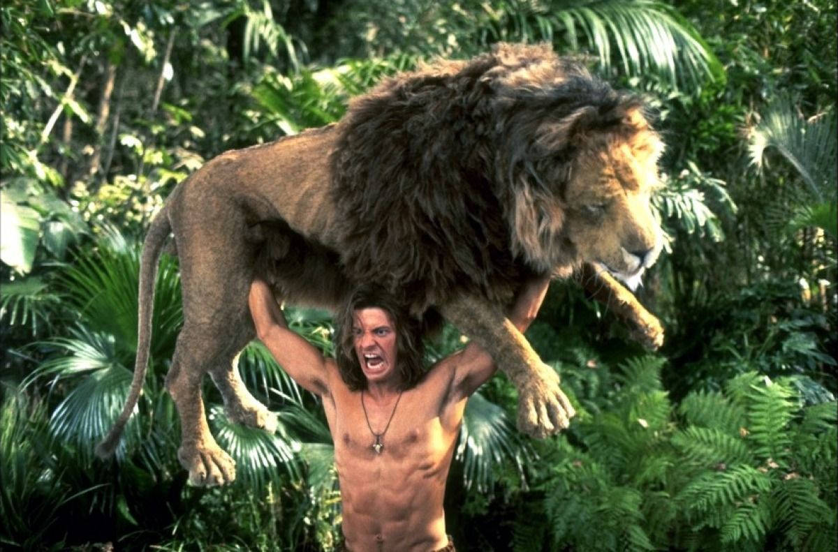 "George of The Jungle demonstrates strength by effortlessly lifting a lion." Wallpaper