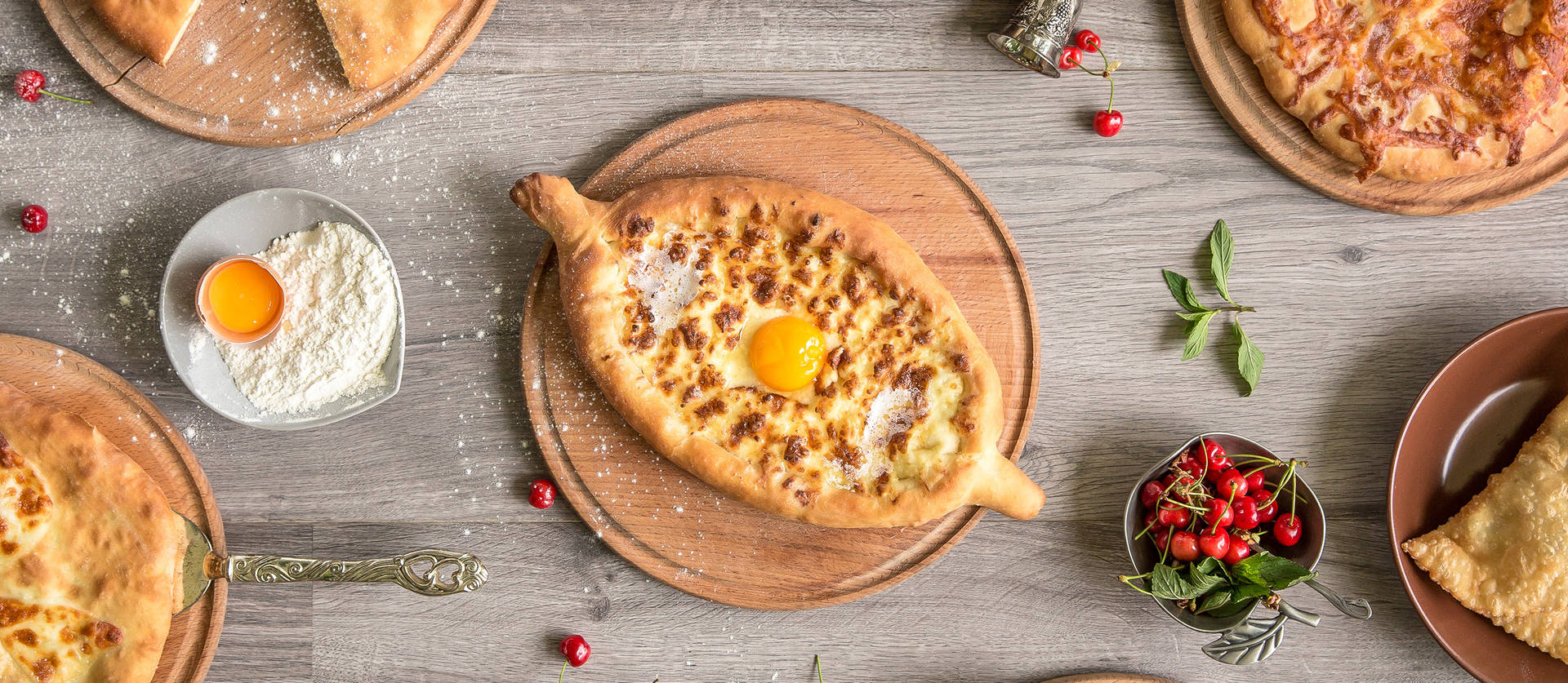 Indulge in a piece of Georgia with this artistic overhead shot of Khachapuri Wallpaper