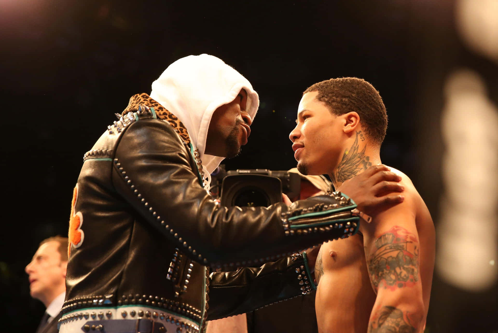 A Boxer Is Embracing Another Boxer In The Ring Wallpaper