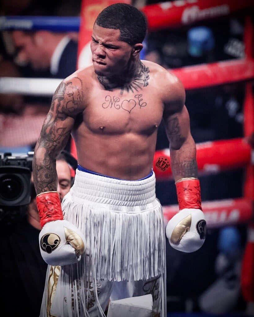 A Boxer With Tattoos Standing In The Ring Wallpaper