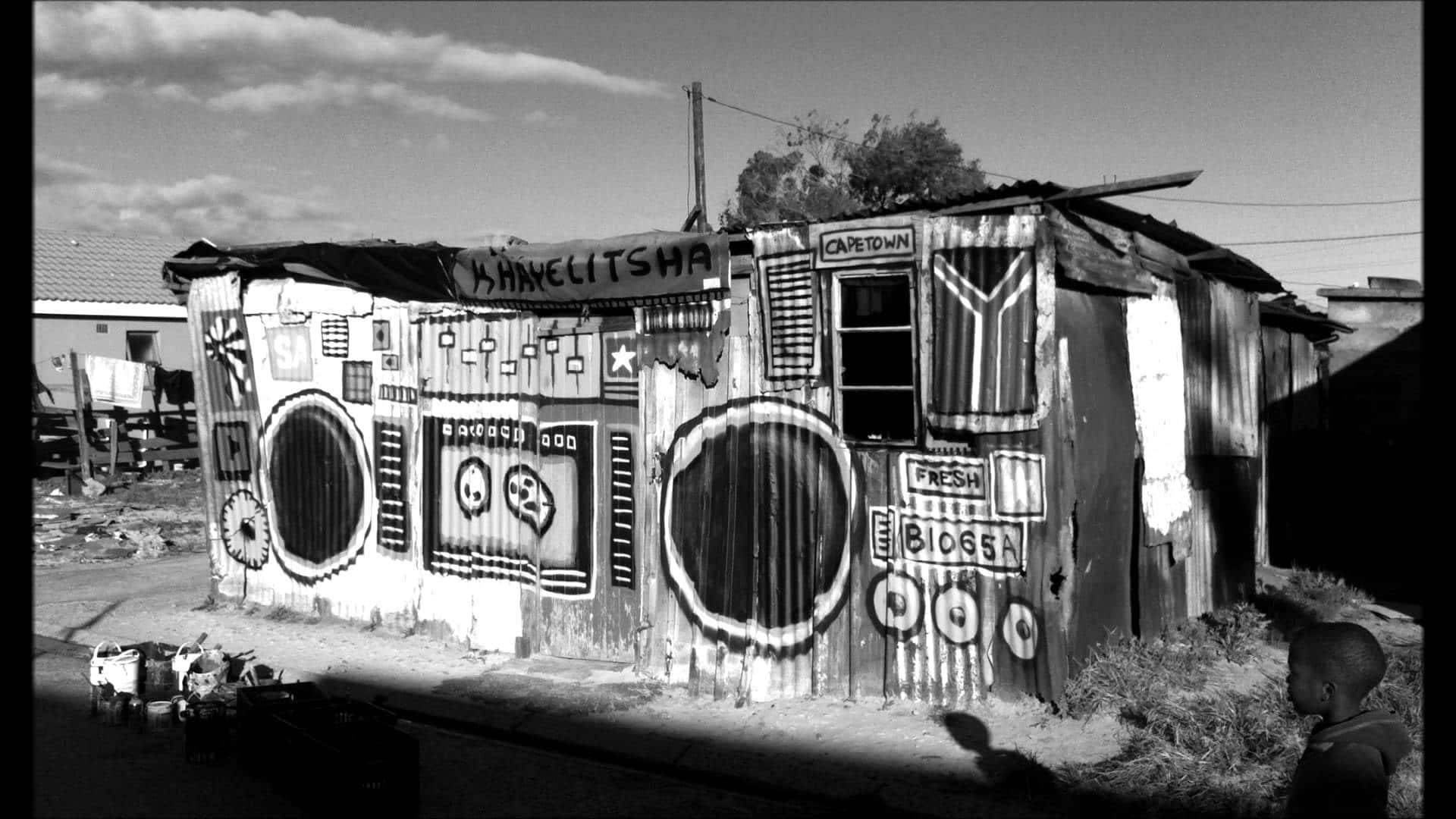 A Black And White Photo Of A Shack With Speakers Wallpaper