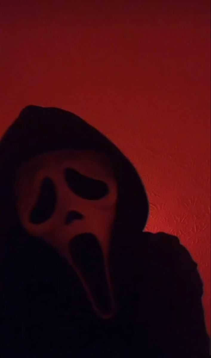 Foreboding Image of Ghostface in a Red Room Wallpaper