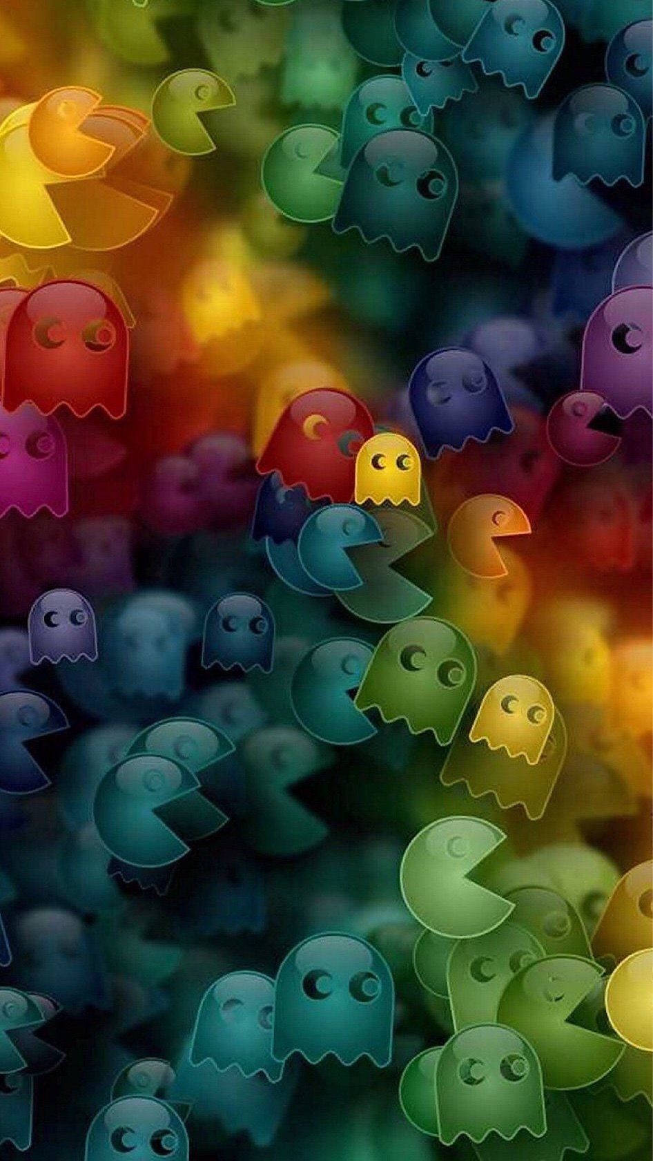 Spøgelser og Pac Man video spil ikoner danse over den livlige baggrund. Wallpaper