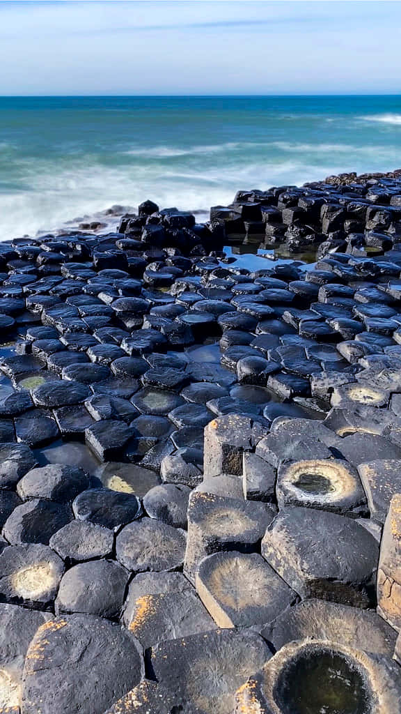 Magnificent View of Giant's Causeway against the Blue Ocean Wallpaper