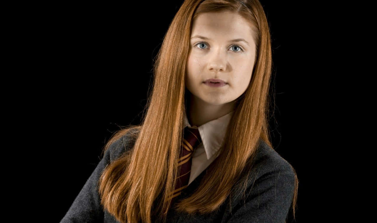Ginny Weasley casting a spell at Hogwarts School in Harry Potter Wallpaper