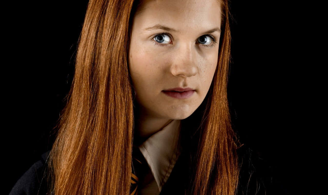 Ginny Weasley casting a spell in a captivating scene Wallpaper