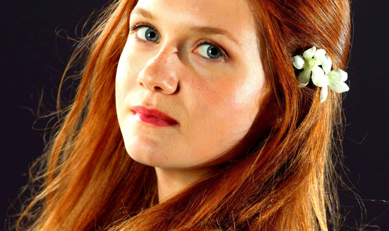 Magical Ginny Weasley in Action Wallpaper