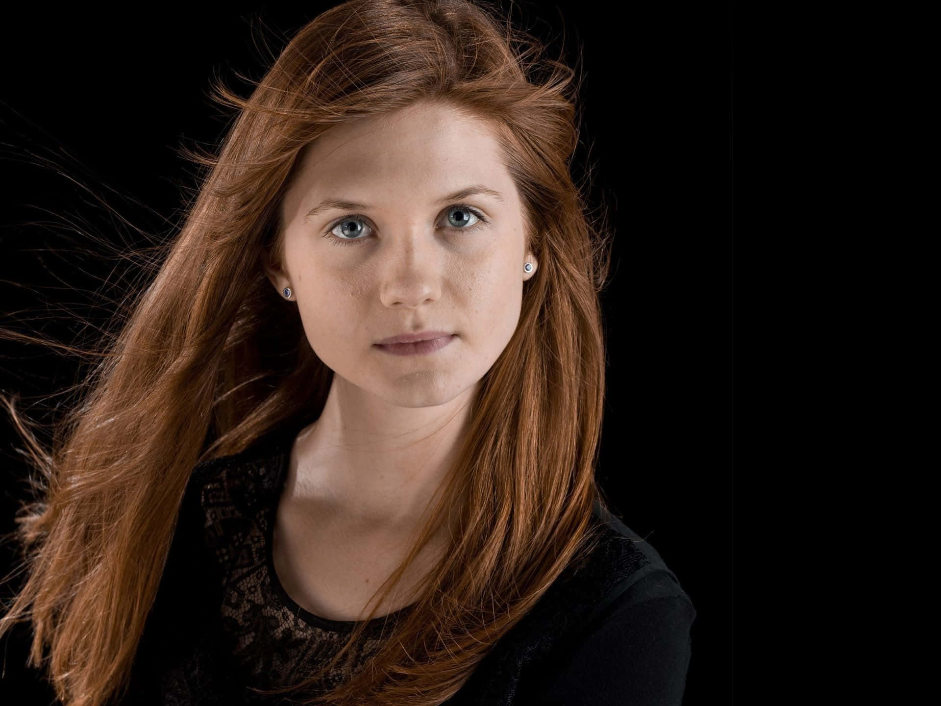 Ginny Weasley in a magical setting, casting spells Wallpaper