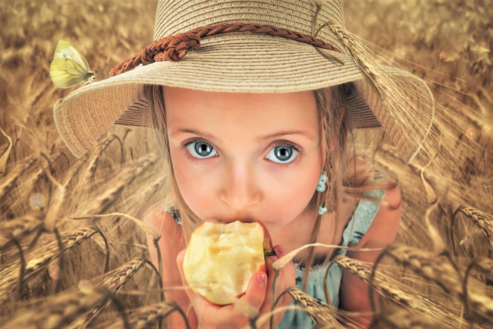 Girl Eating Apple In Wheat Field Wallpaper