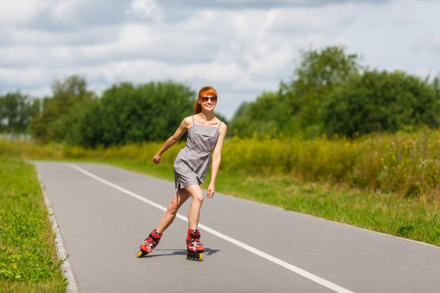 Girl Enjoys Rollerblading Country Road Wallpaper
