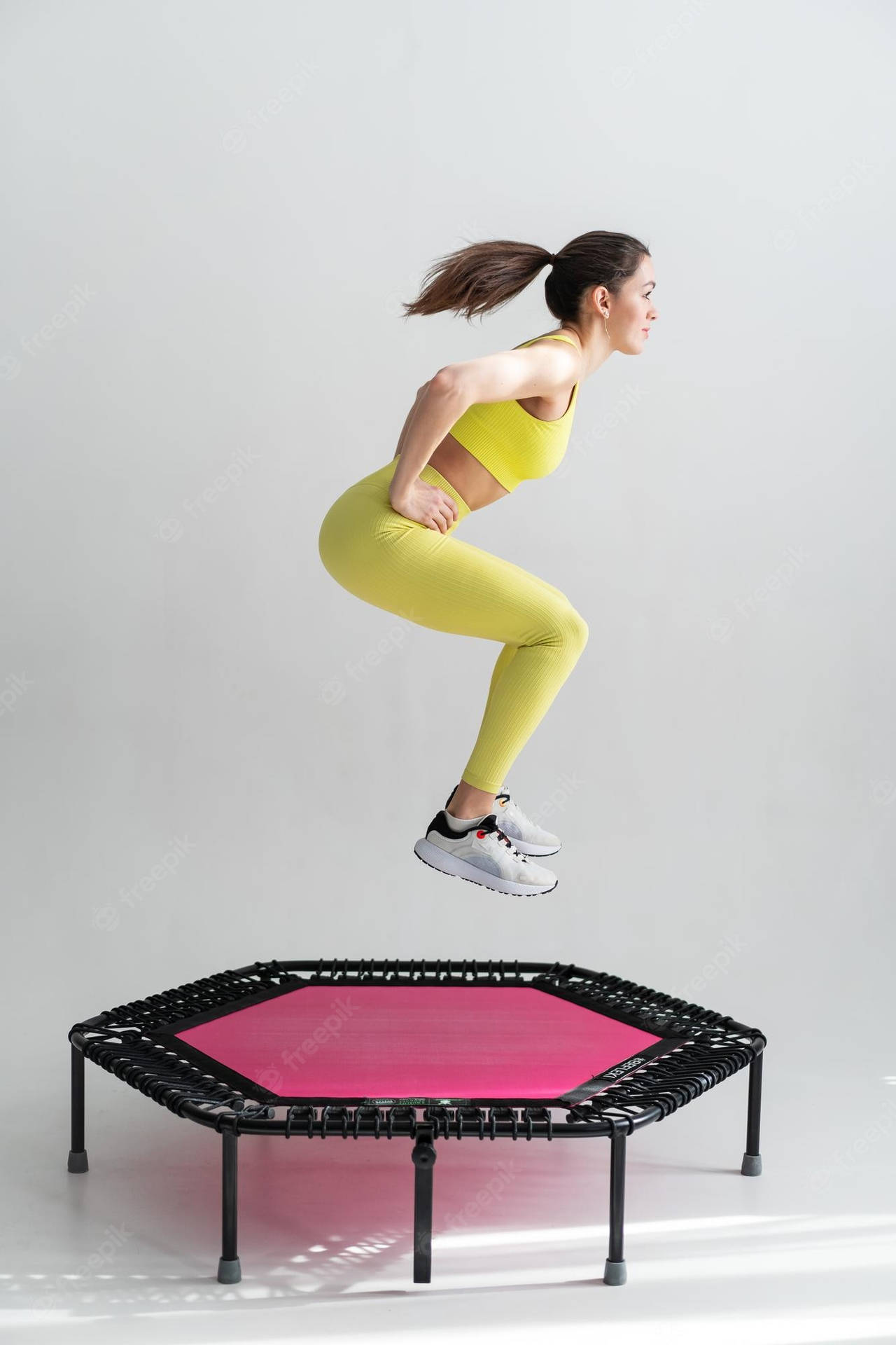Girl Exercising On A Pink Hexagonal Trampoline Wallpaper