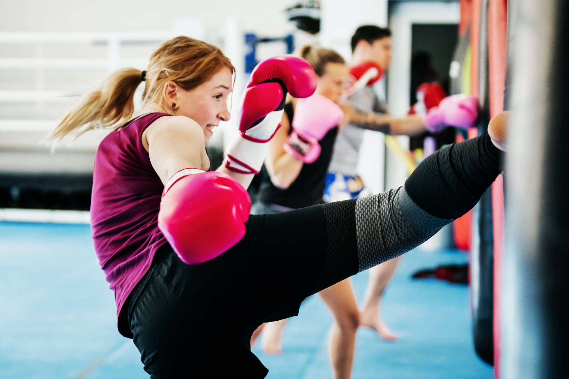 Girl Kickboxing Training At A Gym Wallpaper