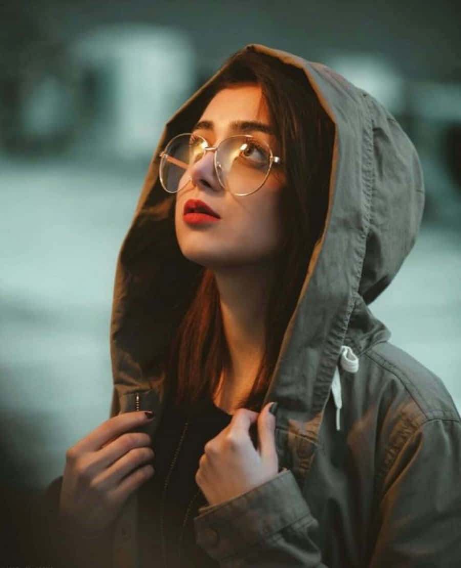 A Woman Wearing Glasses And A Hoodie