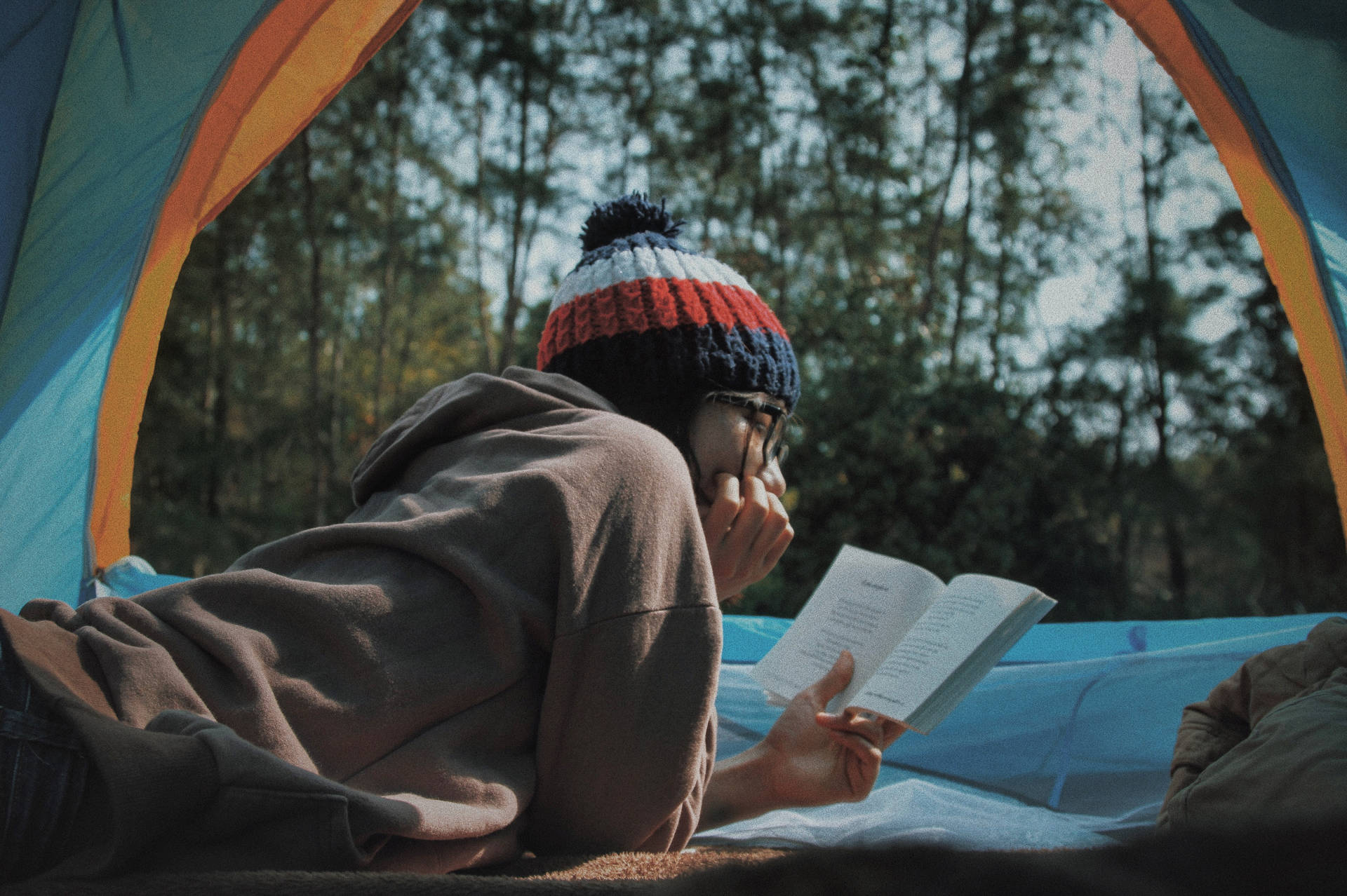 Girl Reading Book At Campsite Wallpaper