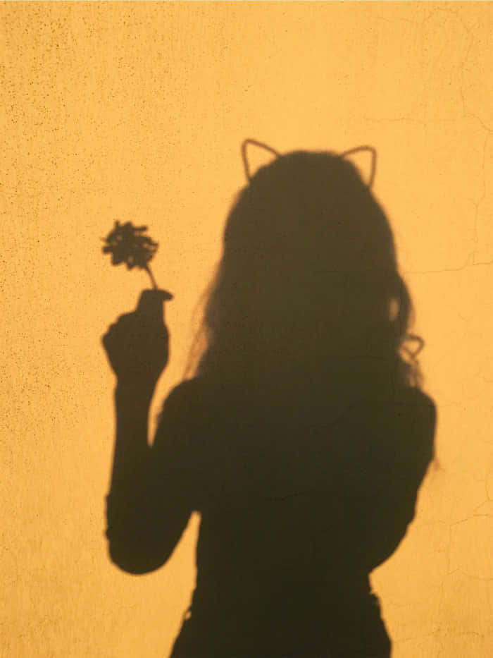 A Shadow Of A Girl Holding A Flower