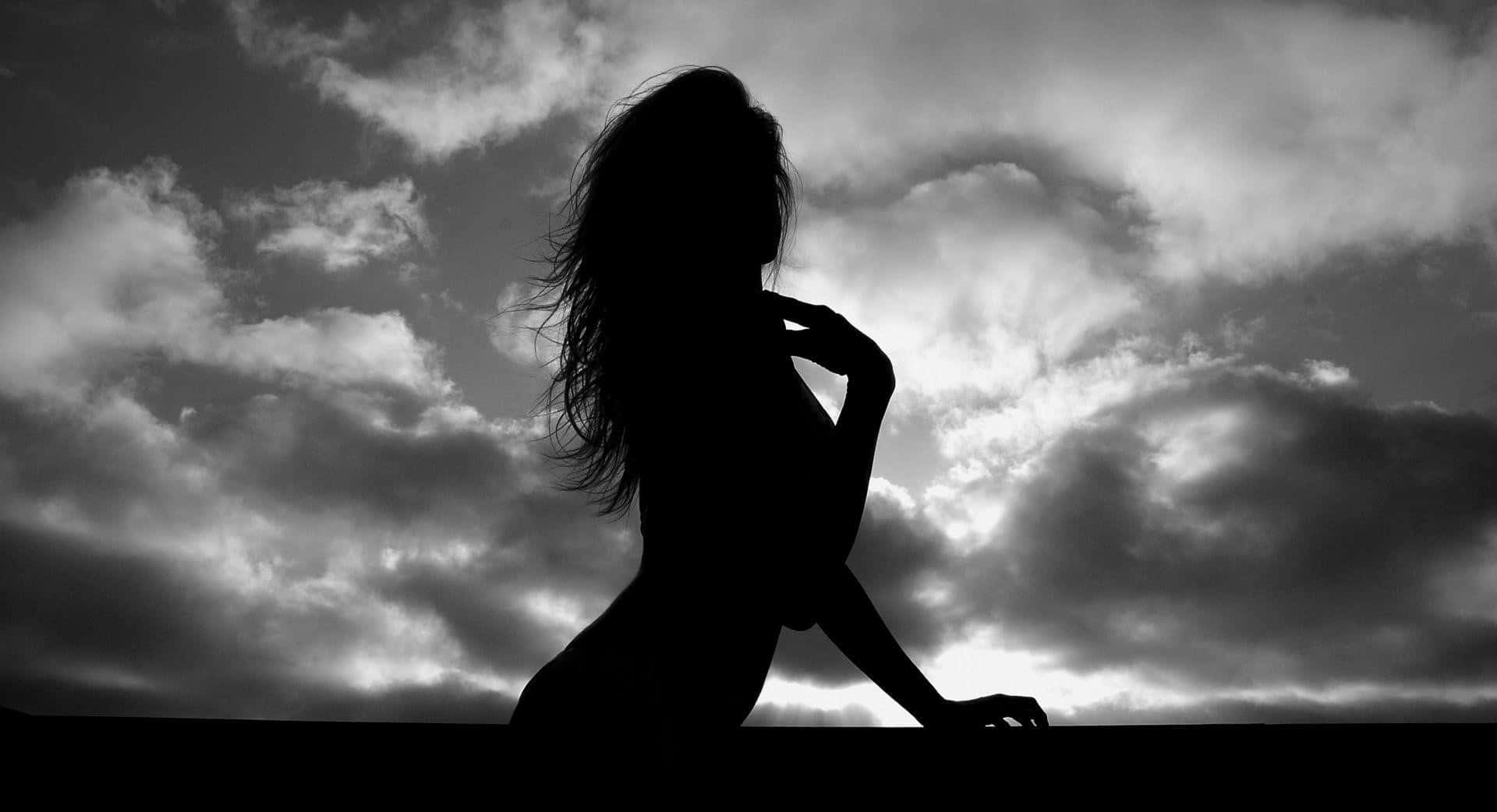 A Woman Is Silhouetted Against The Sky