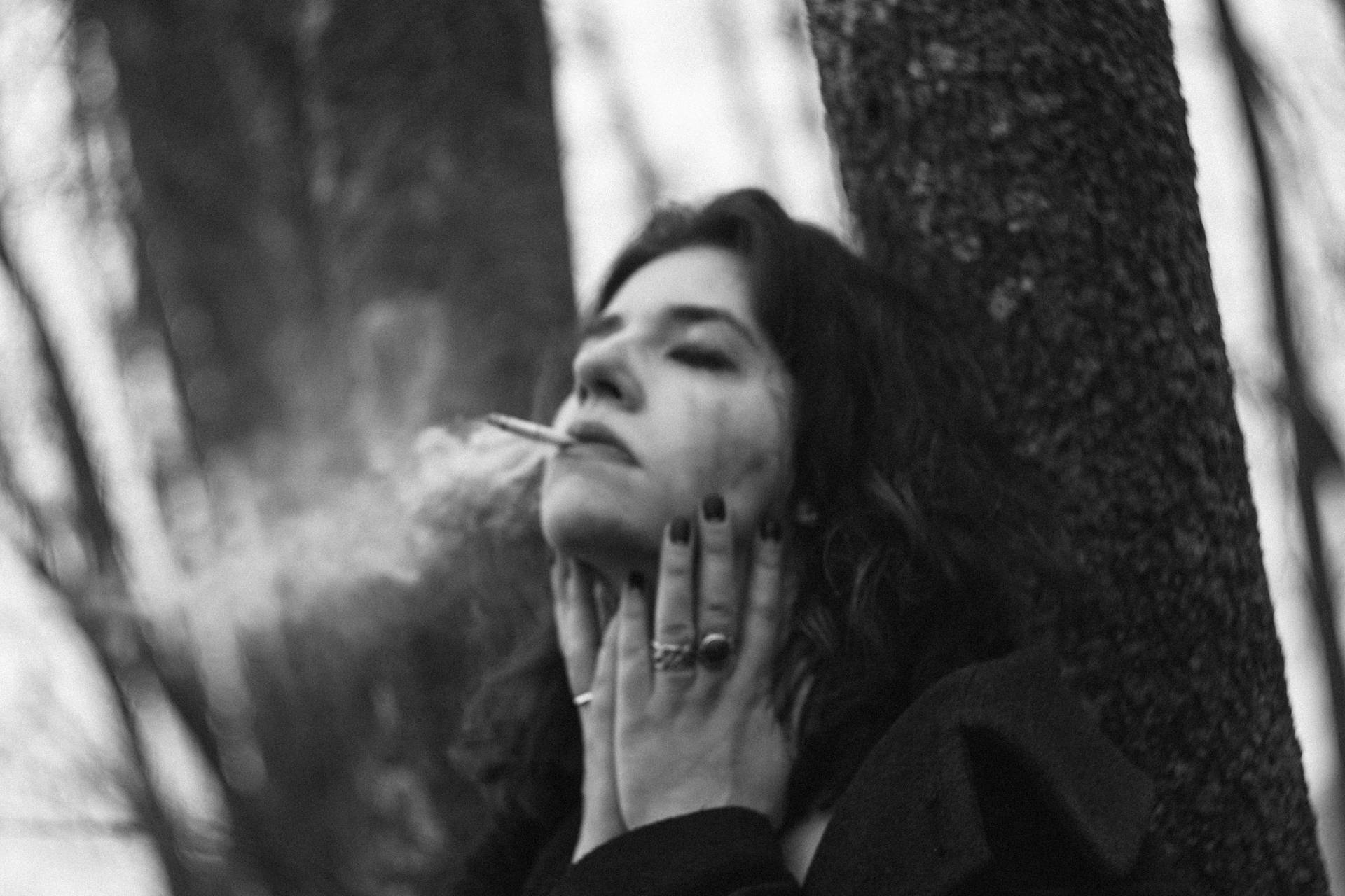 Girl Smoking Under Tree Wallpaper