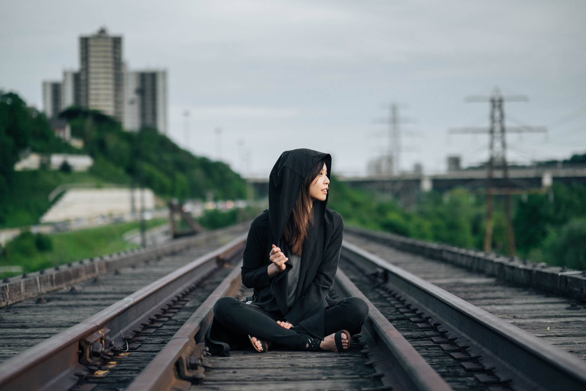 Girl Wearing Hoodie On Train Tracks Wallpaper
